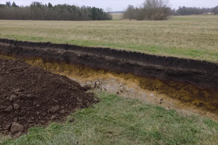 An open soil pit showing the soil profile horizons on an Indiana property